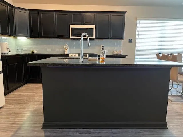 a kitchen with a sink and wooden cabinets