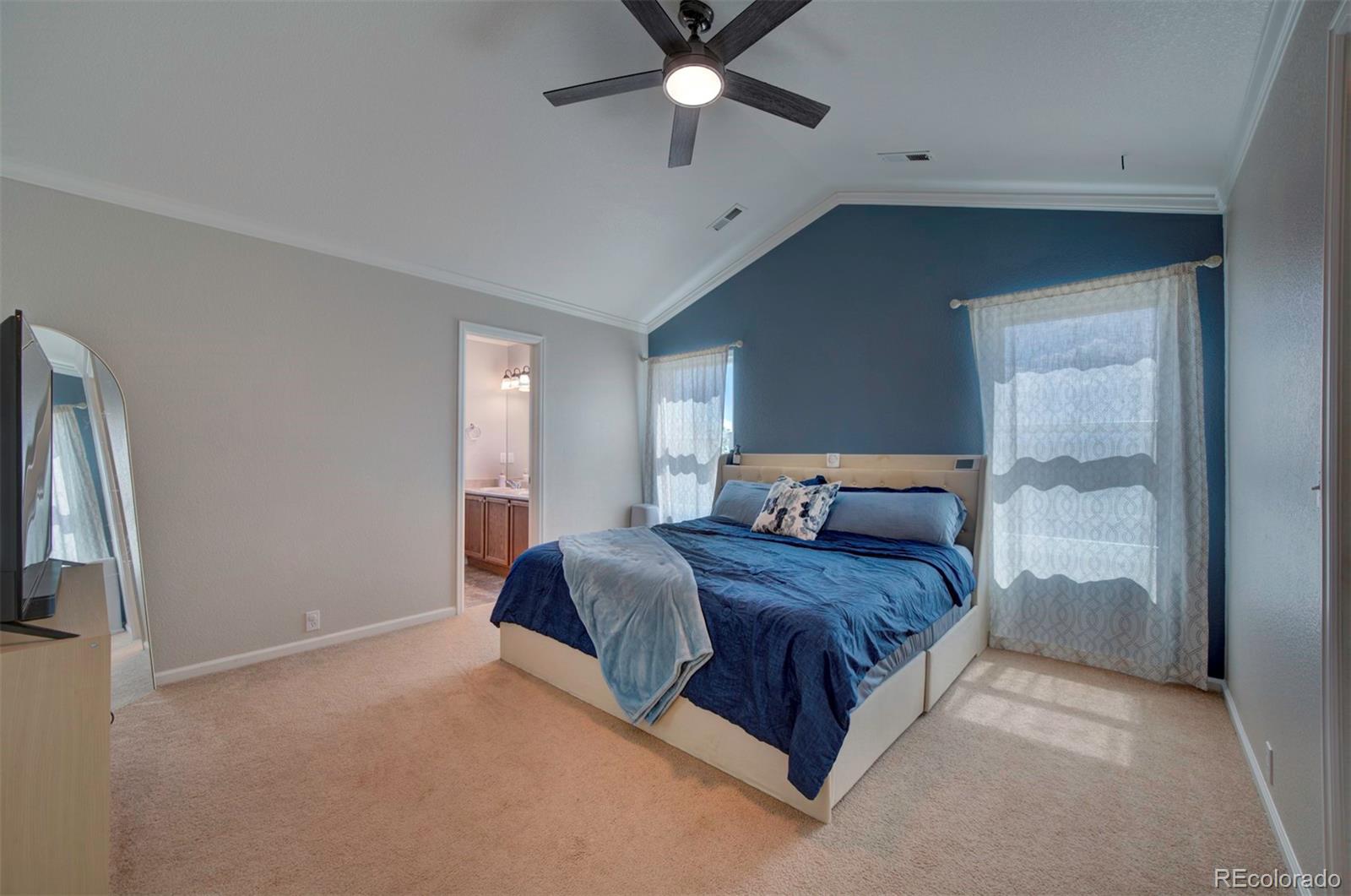 9364 Prairie Dunes Road Peyton, CO 80831 - Photo 11 of 18 a bed sitting in a spacious bedroom next to a window