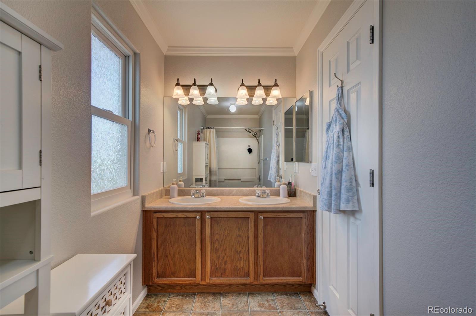 9364 Prairie Dunes Road Peyton, CO 80831 - Photo 12 of 18 a bathroom with a double vanity sink mirror and bathtub