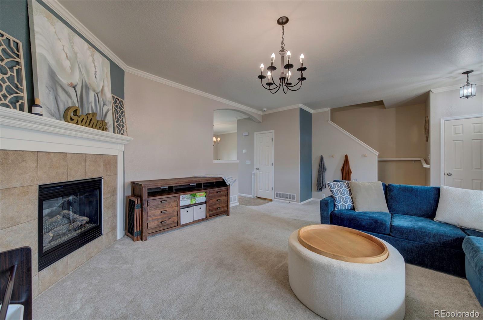 9364 Prairie Dunes Road Peyton, CO 80831 - Photo 4 of 18 a living room with furniture and a fireplace