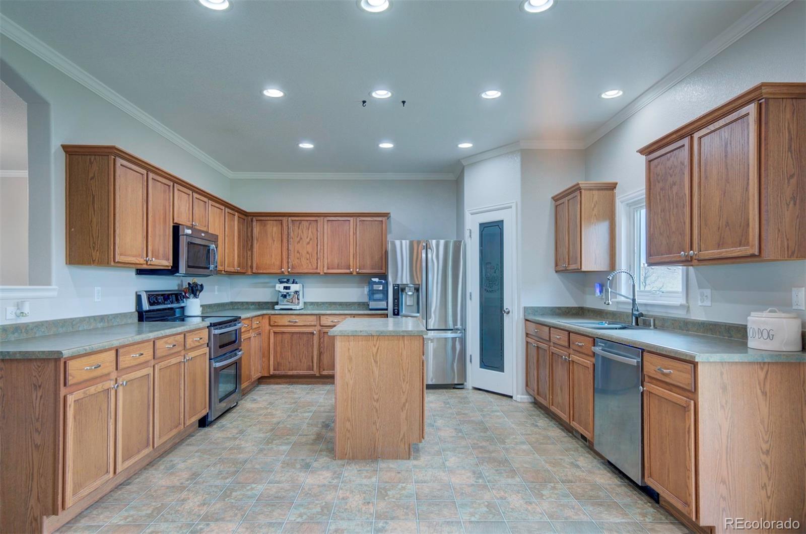 9364 Prairie Dunes Road Peyton, CO 80831 - Photo 6 of 18 a kitchen with a sink microwave and cabinets