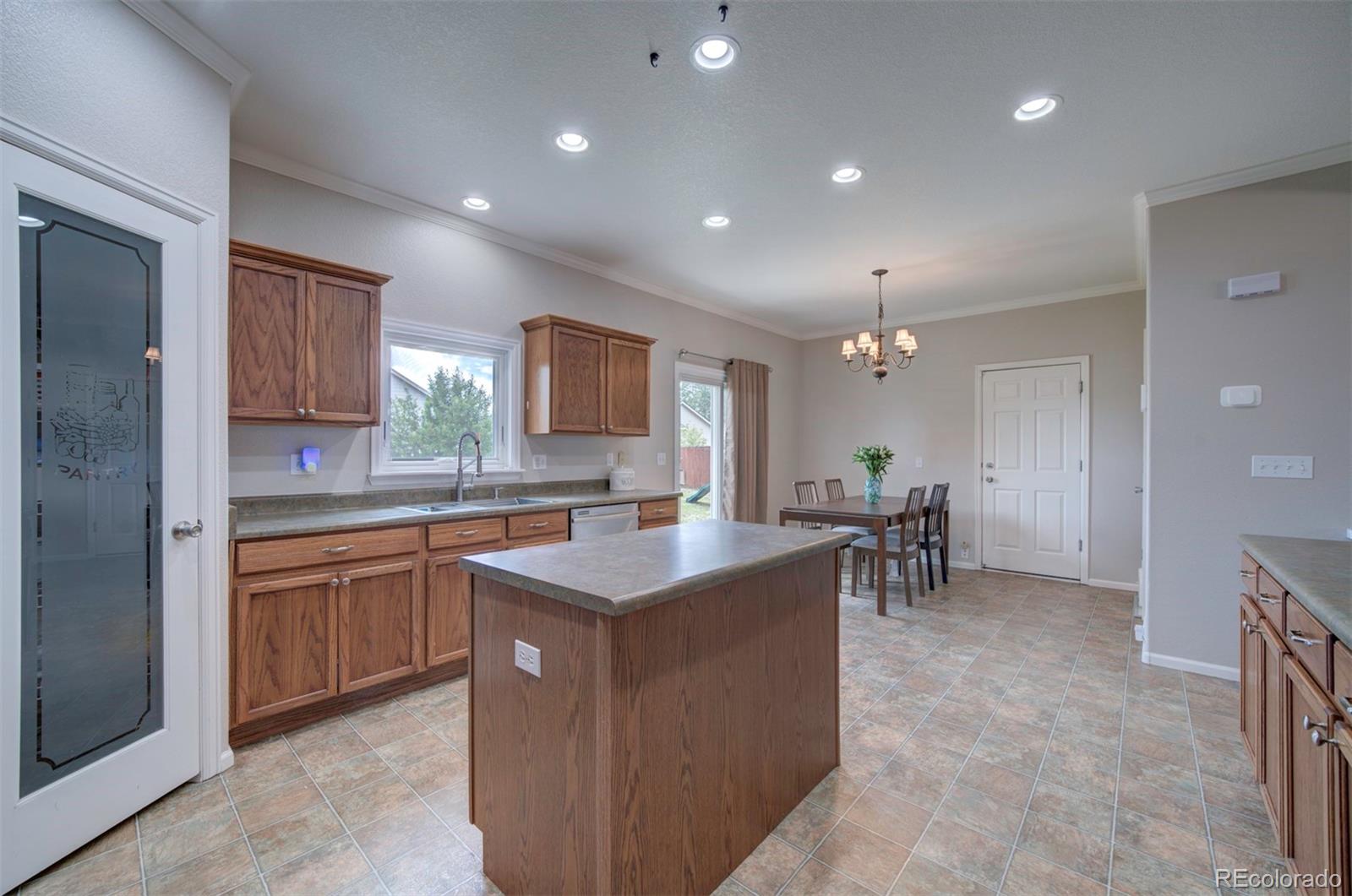 9364 Prairie Dunes Road Peyton, CO 80831 - Photo 7 of 18 a kitchen with sink cabinets and window
