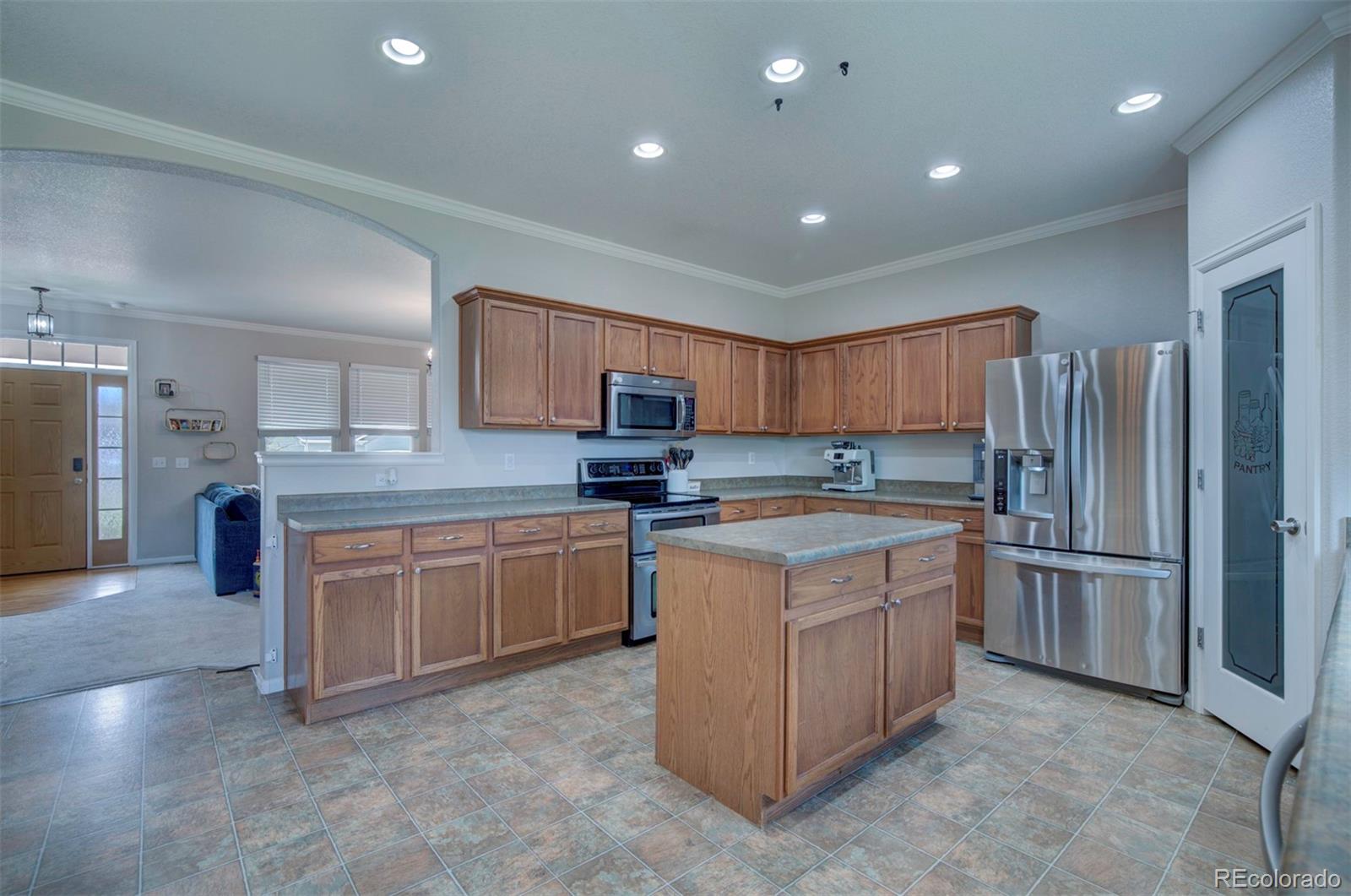 9364 Prairie Dunes Road Peyton, CO 80831 - Photo 8 of 18 a kitchen with stainless steel appliances granite countertop a refrigerator and a stove top oven