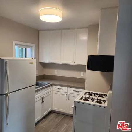 a kitchen with a refrigerator and a stove