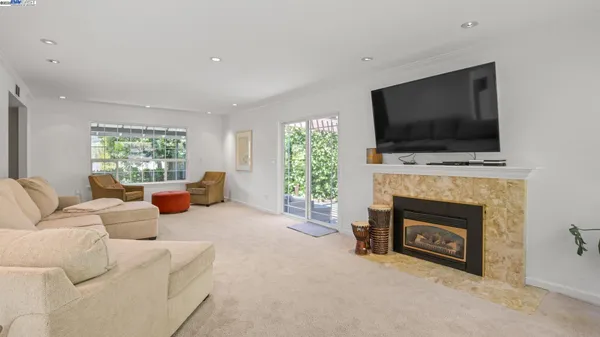 a living room with furniture toys and a large window