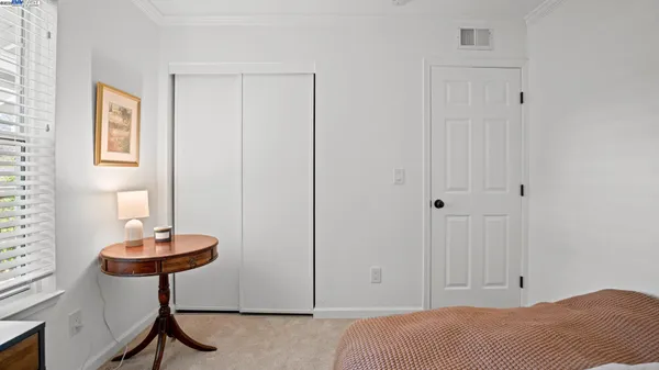 a bedroom with a large bed and a large window