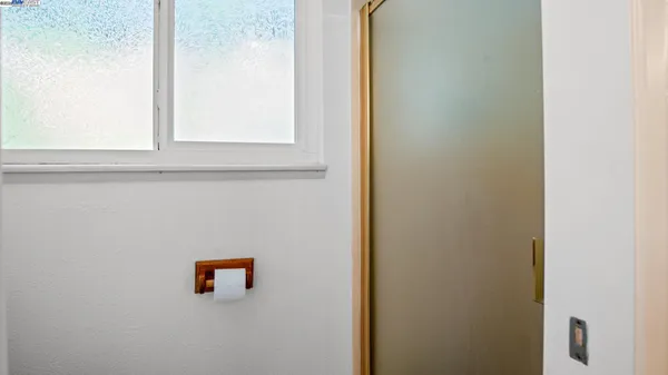 a bathroom with a sink toilet vanity and window