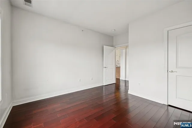 a view of an empty room and wooden floor