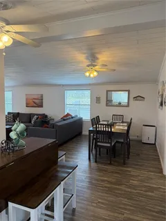 a view of a dining room with furniture and wooden floor