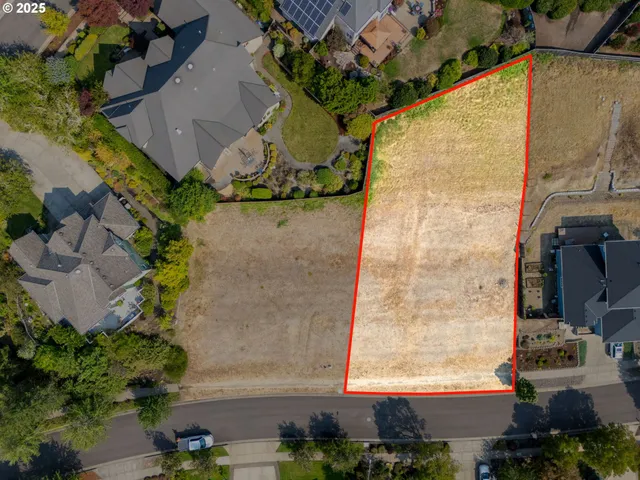 an aerial view of a residential houses with outdoor space