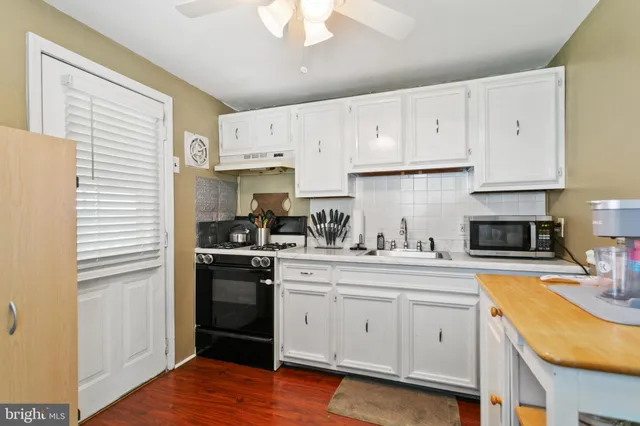 a kitchen with cabinets appliances and a window