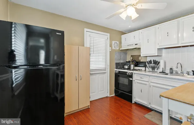 a kitchen with a refrigerator and cabinets