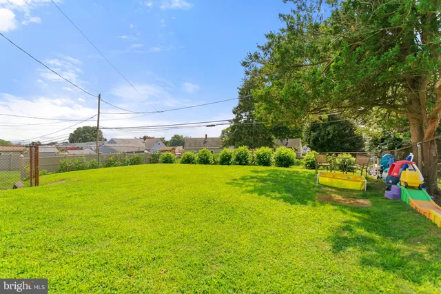 a view of a house with a yard and sitting area