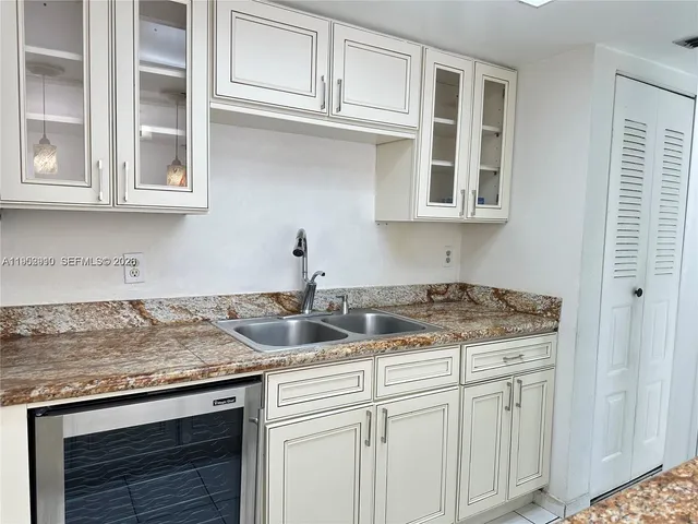 a kitchen with stainless steel appliances granite countertop a sink and cabinets