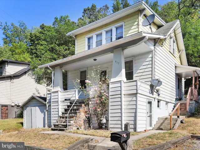 a view of a white house with a sink and entryway