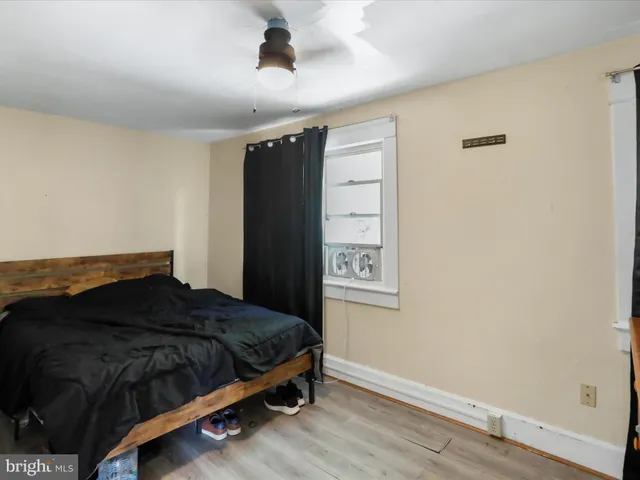 a bedroom with a bed and a window