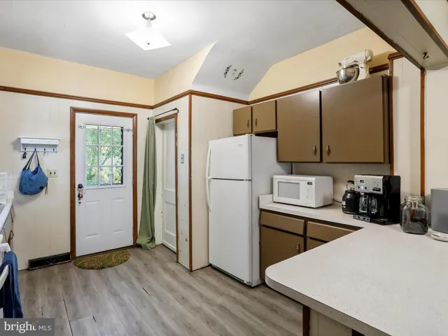 a kitchen with a refrigerator a sink and cabinets