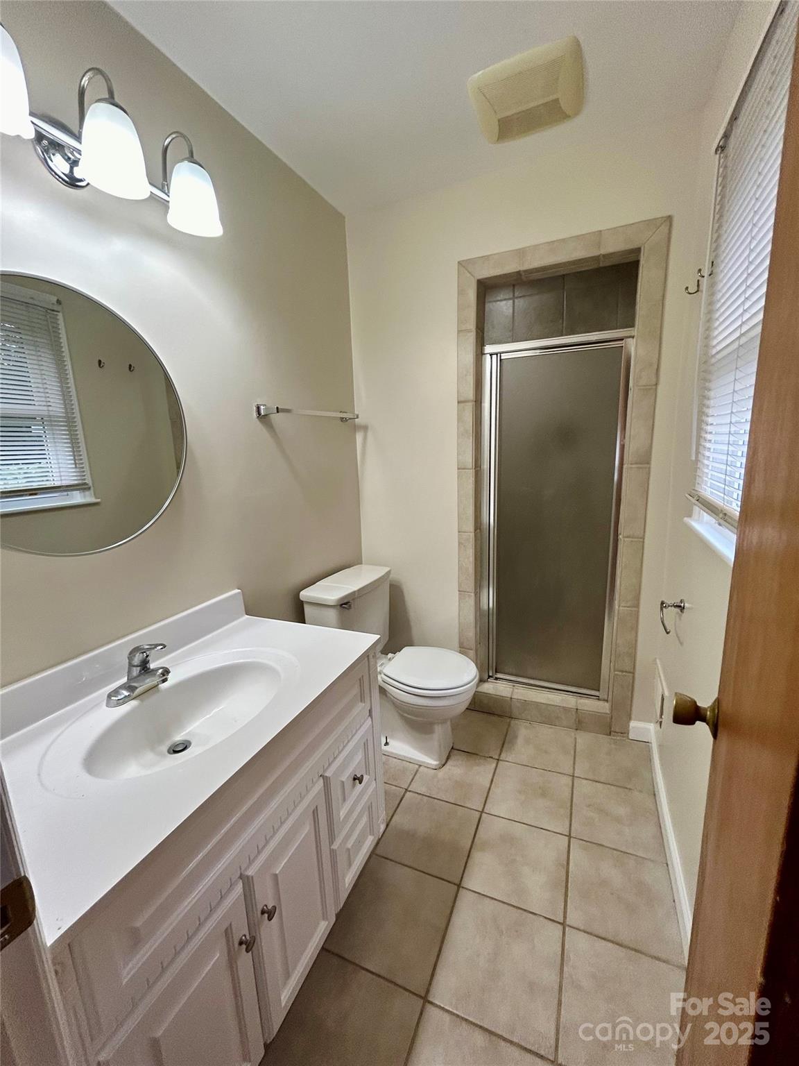 5734 Brookhaven Road Charlotte, NC 28210 - Photo 11 of 12 a spacious bathroom with a double vanity sink toilet and shower