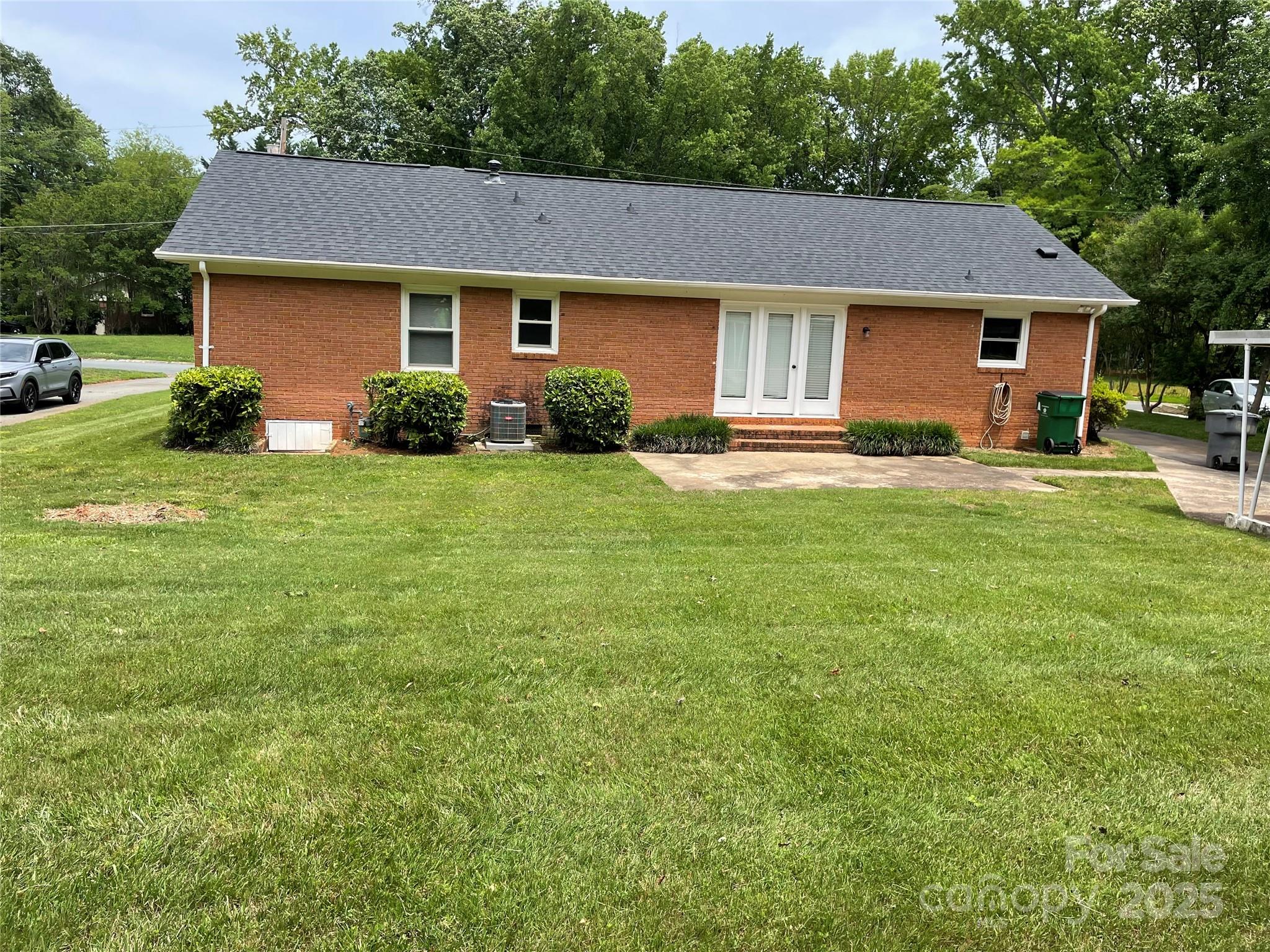5734 Brookhaven Road Charlotte, NC 28210 - Photo 2 of 12 a front view of a house with a garden and porch