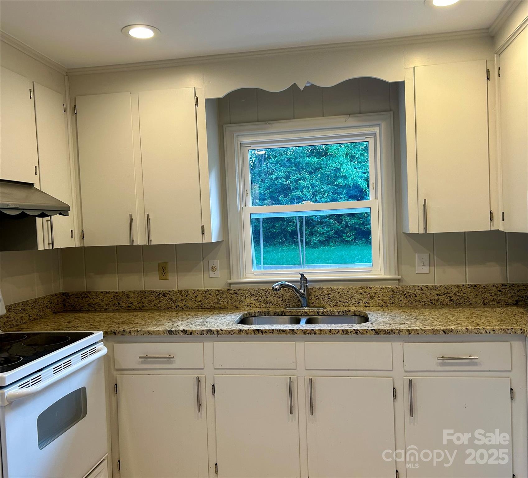 5734 Brookhaven Road Charlotte, NC 28210 - Photo 6 of 12 a kitchen with granite countertop white cabinets and a window