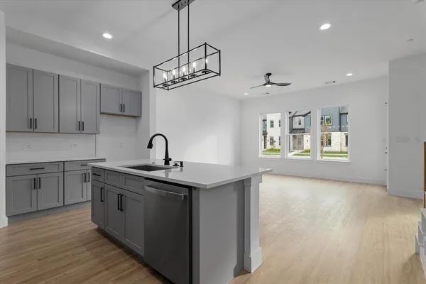 a kitchen with stainless steel appliances granite countertop a sink a stove a refrigerator and cabinets