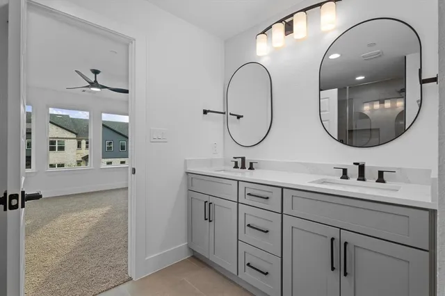 a bathroom with a granite countertop toilet a sink and a mirror