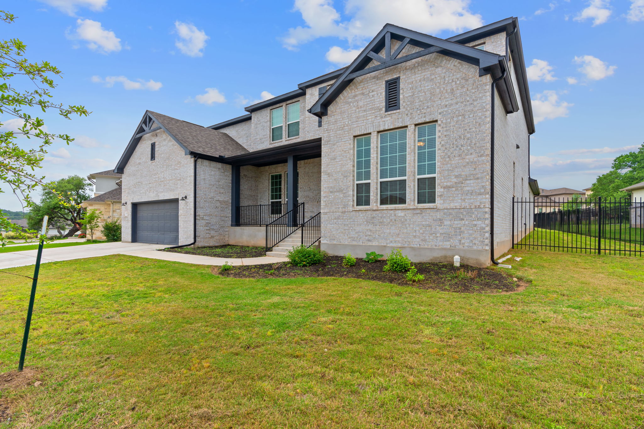 309 Pear Tree Lane Austin, TX 78737 - Photo 4 of 39 a front view of a house with a yard