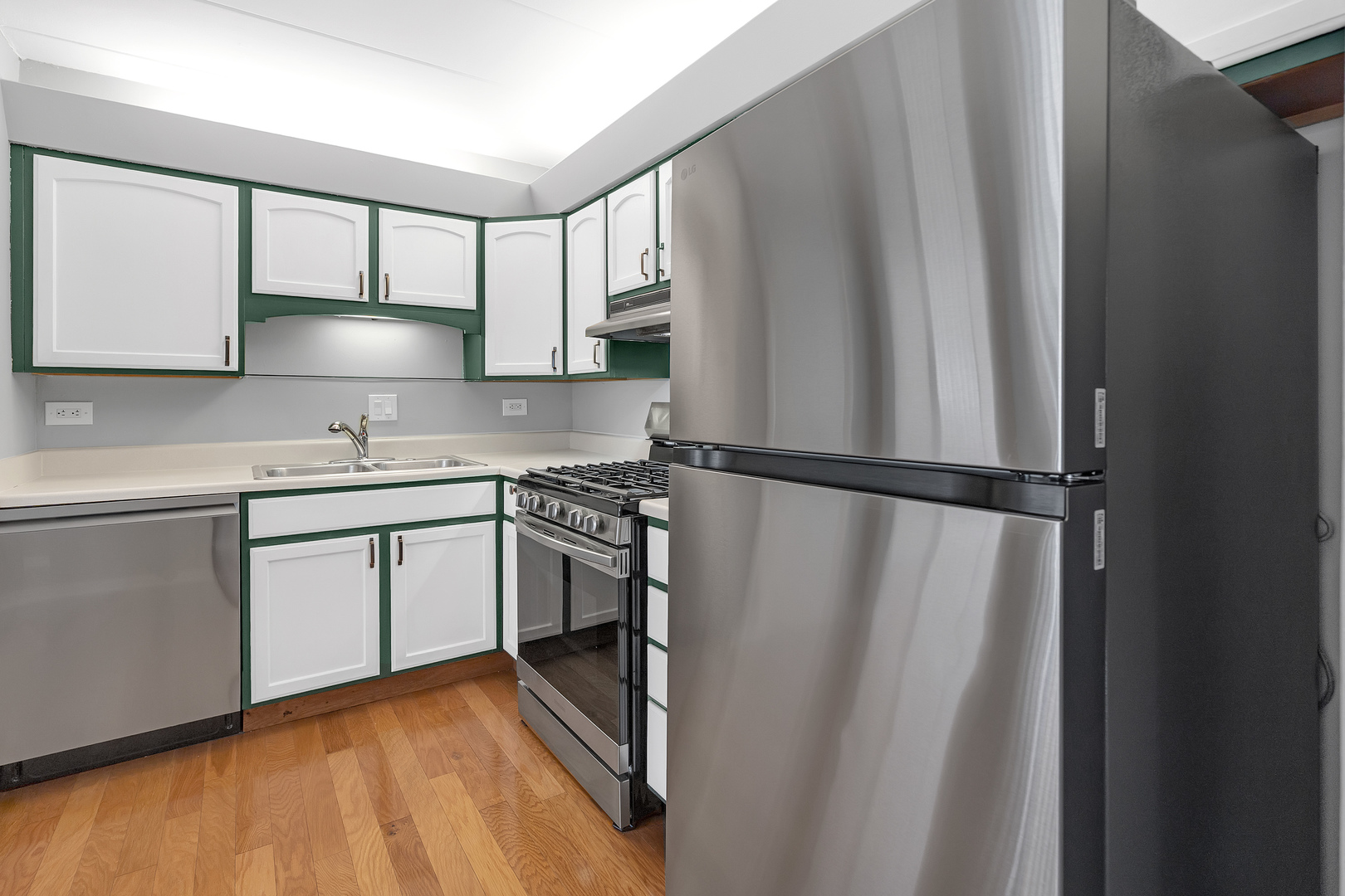 659 South Des Plaines River Road, Unit 2A Des Plaines, IL 60016 - Photo 18 of 28 a kitchen with a sink a refrigerator and white cabinets