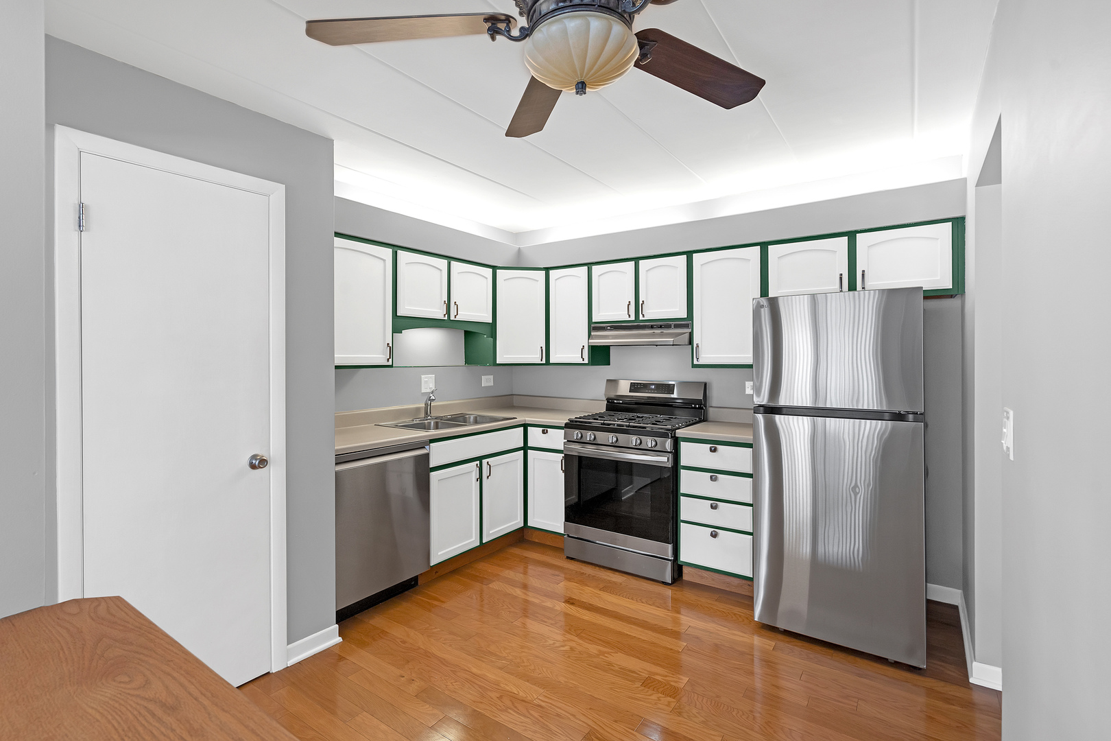 659 South Des Plaines River Road, Unit 2A Des Plaines, IL 60016 - Photo 5 of 28 a kitchen with stainless steel appliances granite countertop a stove a refrigerator and a refrigerator