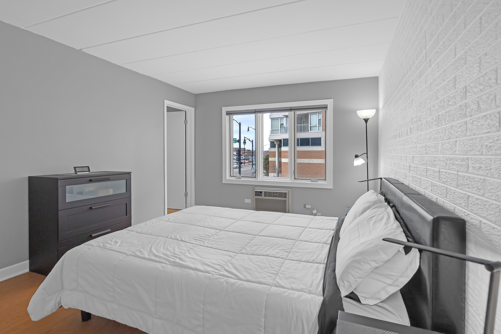 659 South Des Plaines River Road, Unit 2A Des Plaines, IL 60016 - Photo 7 of 28 a bedroom with a bed and a window
