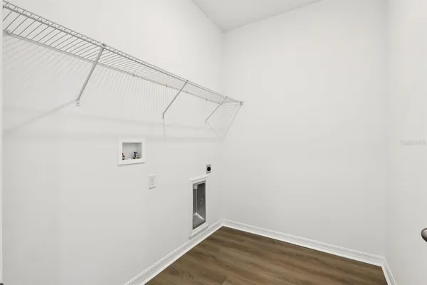 a view of a room with wooden floor