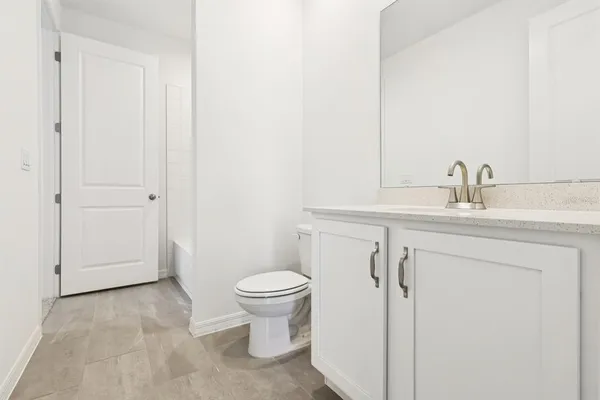 a bathroom with a sink toilet and vanity