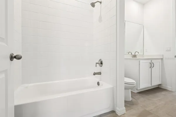 a view of a bathroom with a tub and window