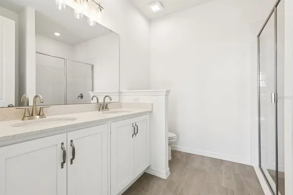 a bathroom with a double vanity sink mirror and
