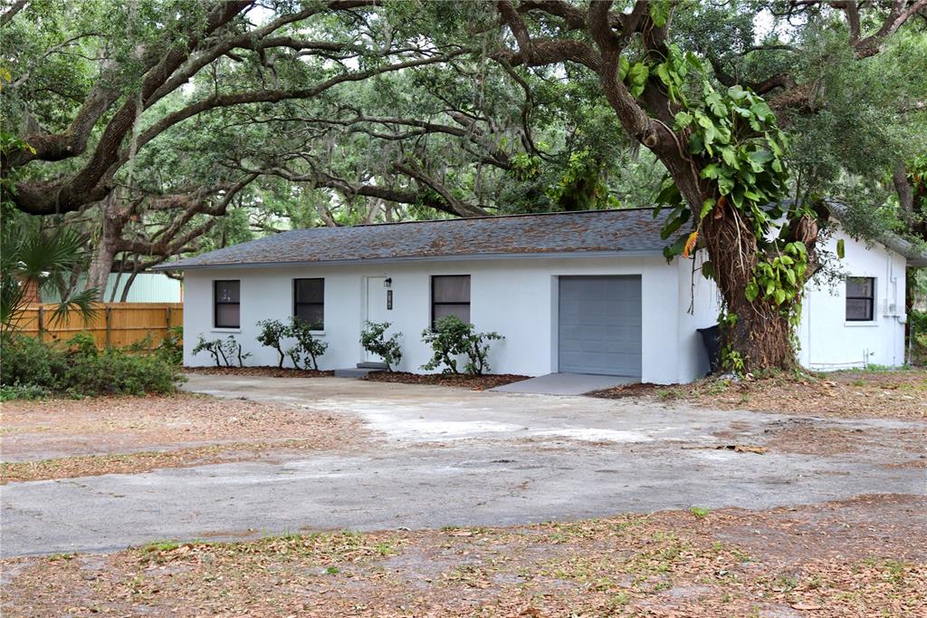 8106 Turkey Creek Road Plant City, FL 33567 - Photo 1 of 1 a front view of a house with a yard and a garage
