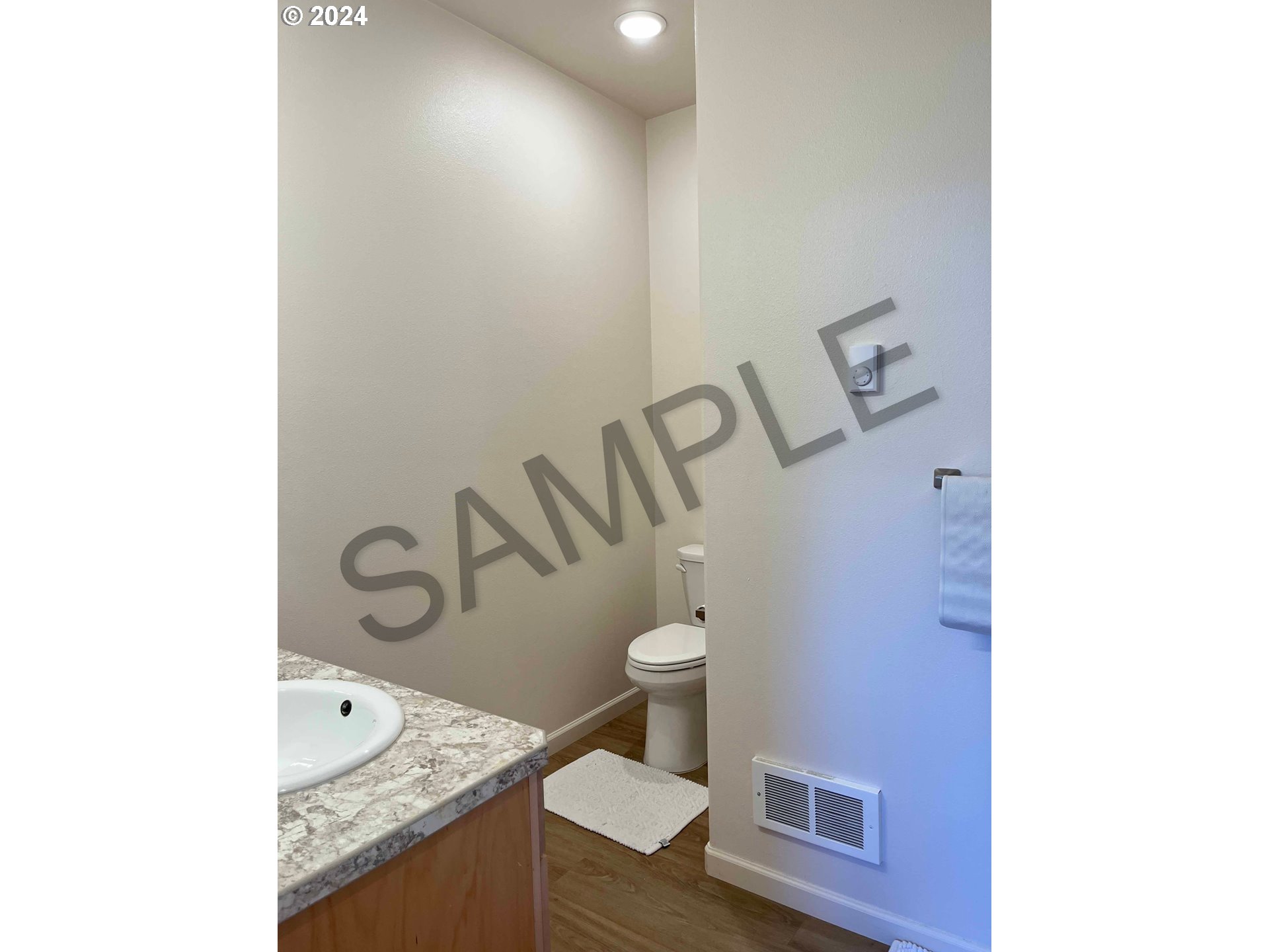 1587 37th Street Florence, OR 97439 - Photo 26 of 47 a bathroom with a granite countertop sink and a toilet