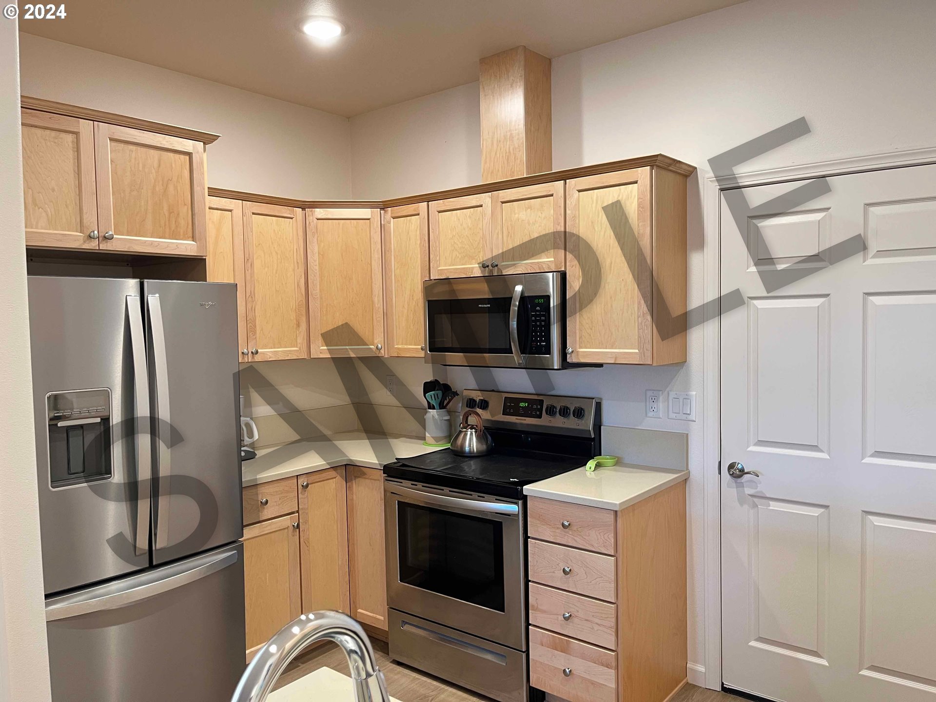 1587 37th Street Florence, OR 97439 - Photo 9 of 47 a kitchen with stainless steel appliances granite countertop a refrigerator stove and microwave