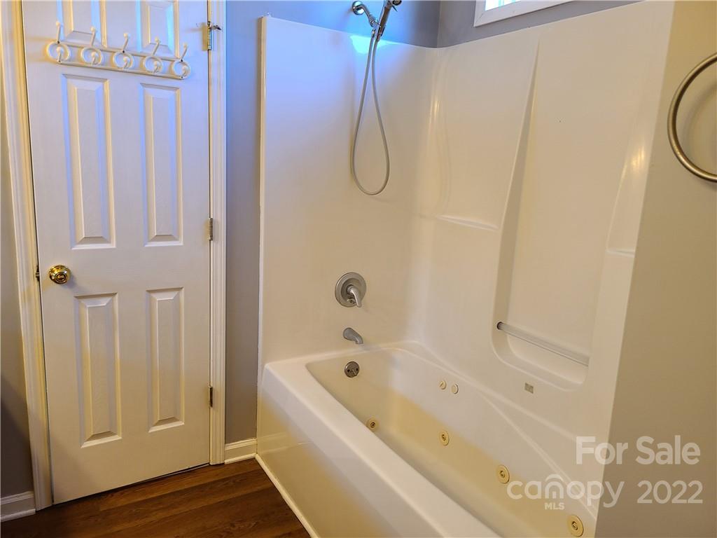 24955 Ridgecrest Road Locust, NC 28097 - Photo 11 of 22 a bathroom with a bathtub and a shower