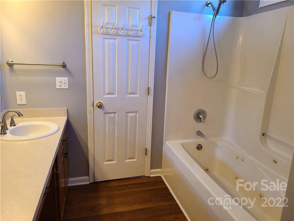24955 Ridgecrest Road Locust, NC 28097 - Photo 12 of 22 a bathroom with a tub a sink and a shower