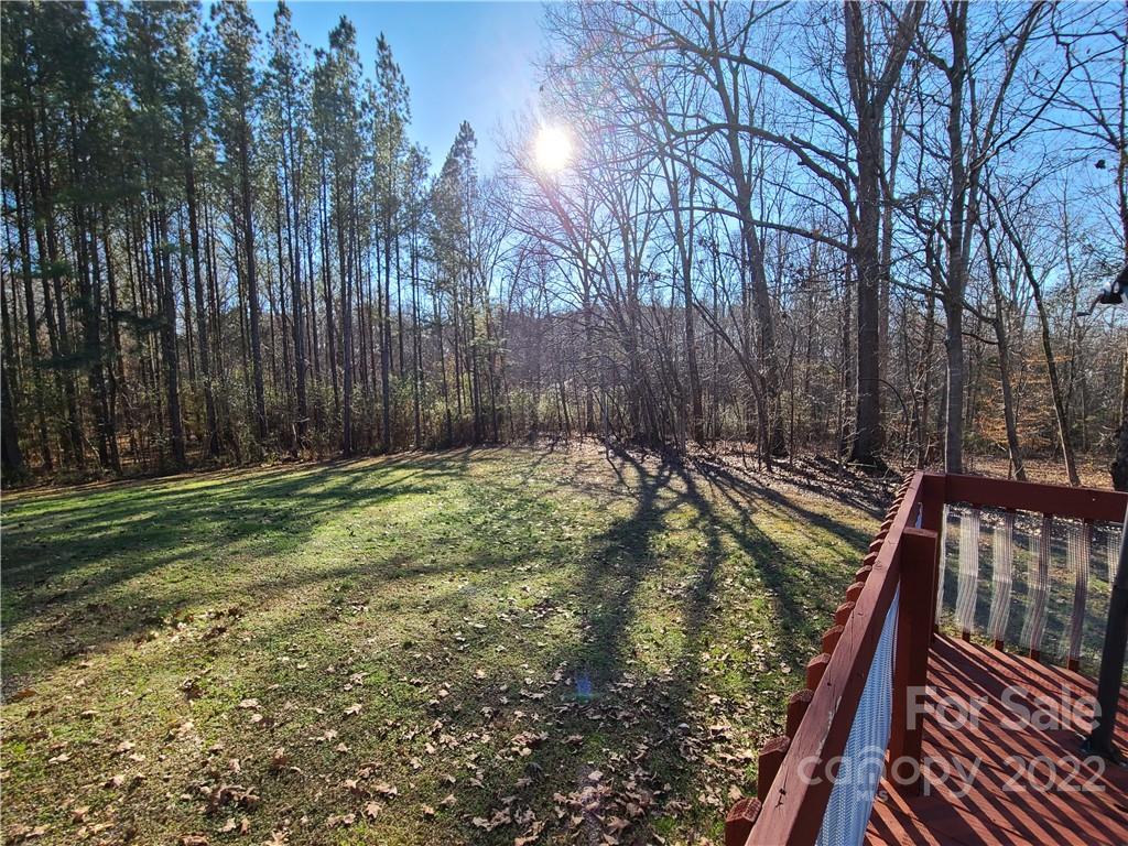 24955 Ridgecrest Road Locust, NC 28097 - Photo 19 of 22 a view of a backyard with large trees