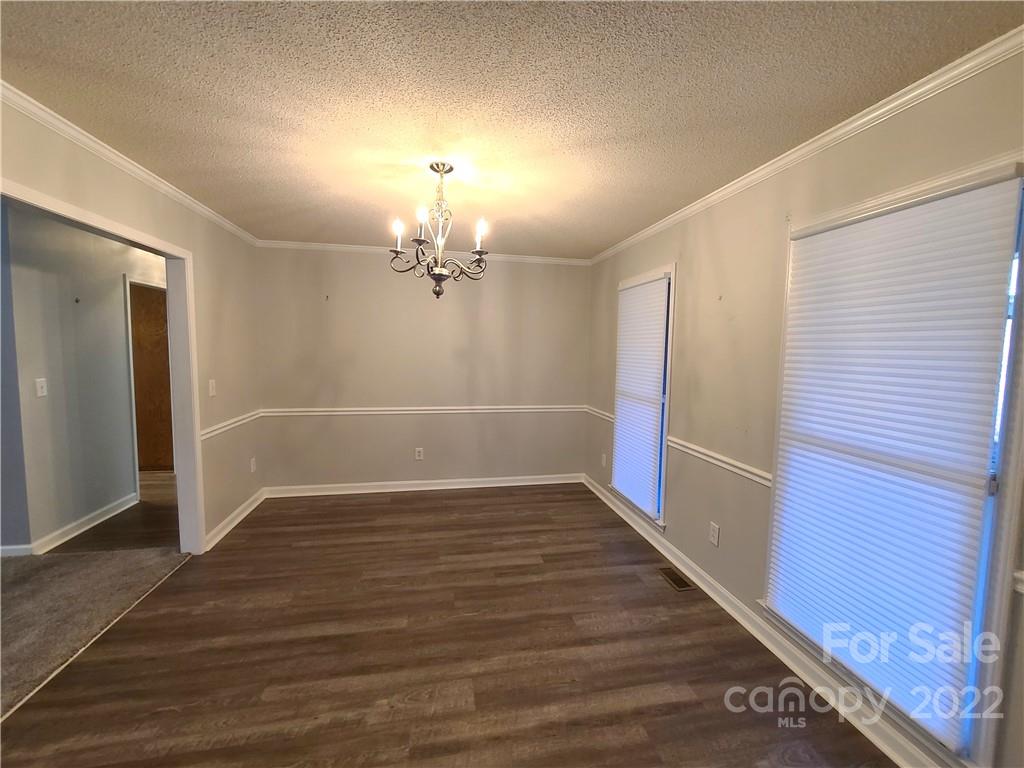 24955 Ridgecrest Road Locust, NC 28097 - Photo 3 of 22 a view of an empty room with wooden floor
