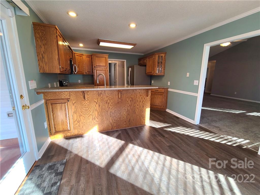 24955 Ridgecrest Road Locust, NC 28097 - Photo 6 of 22 a view of kitchen and wooden floor