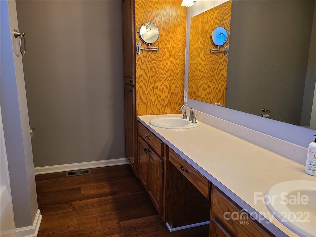 24955 Ridgecrest Road Locust, NC 28097 - Photo 10 of 22 a bathroom with a sink and a mirror
