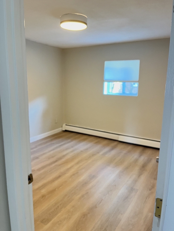 22 Westgate Road, Unit 3 Boston, MA 02467 - Photo 12 of 18 an empty room with a workbench