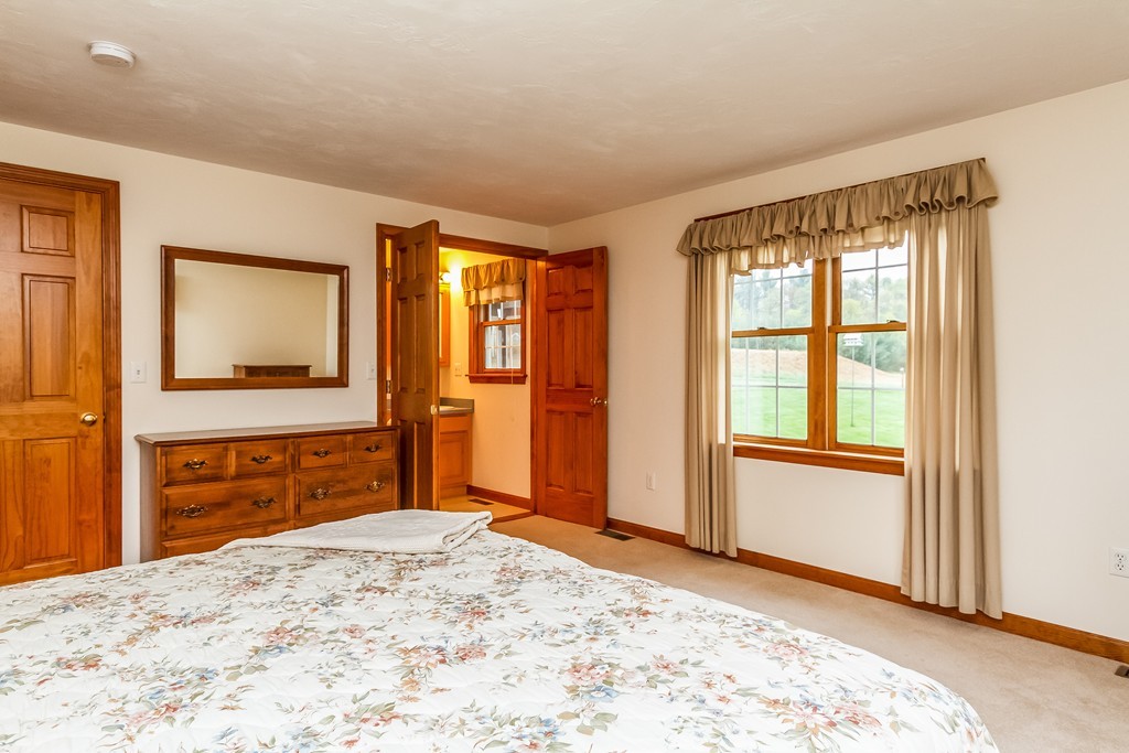 84 Little Turnpike Road Shirley, MA 01464 - Photo 16 of 30 a bedroom with a bed and a dresser
