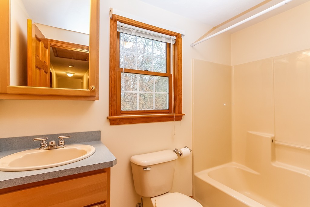 84 Little Turnpike Road Shirley, MA 01464 - Photo 21 of 30 a bathroom with a toilet a sink and a bathtub