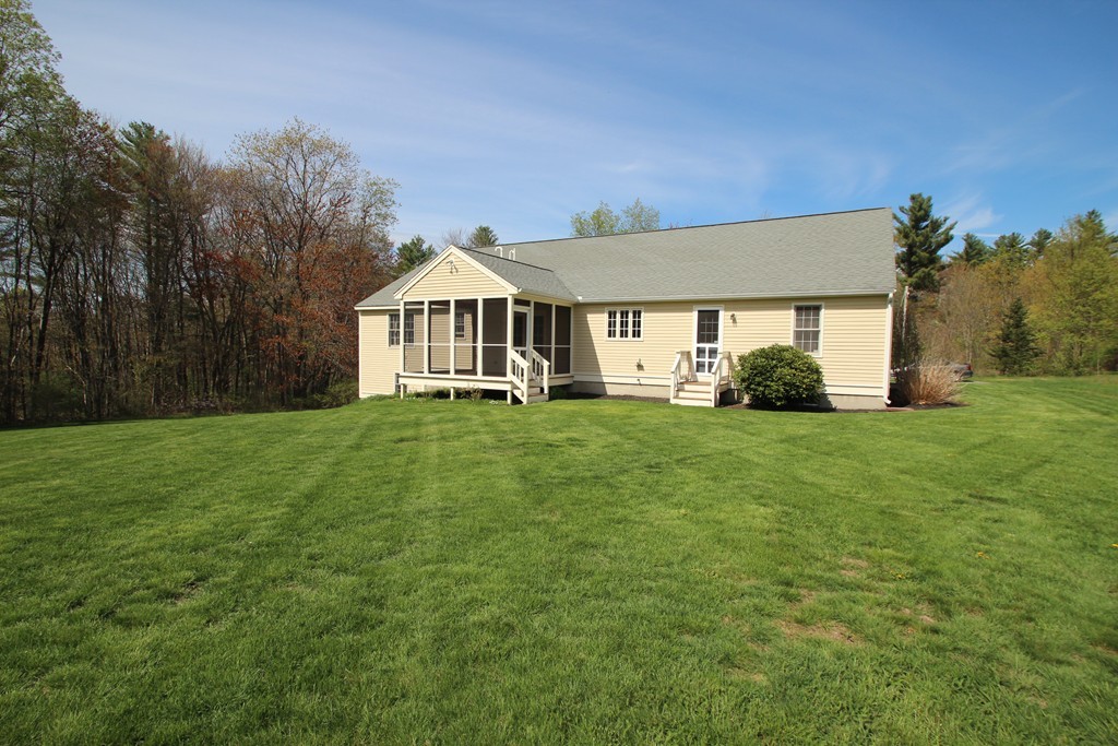 84 Little Turnpike Road Shirley, MA 01464 - Photo 27 of 30 a front view of a house with a yard and trees