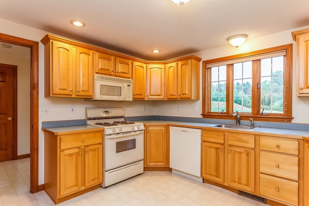 84 Little Turnpike Road Shirley, MA 01464 - Photo 5 of 30 a kitchen with stainless steel appliances granite countertop a stove a sink and a microwave