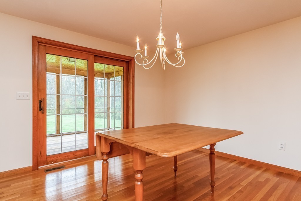 84 Little Turnpike Road Shirley, MA 01464 - Photo 7 of 30 a view of a dining room with furniture wooden floor and chandelier