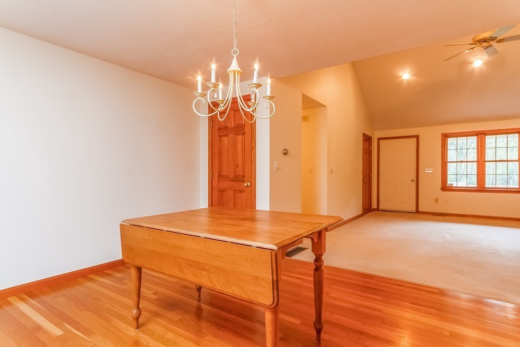 84 Little Turnpike Road Shirley, MA 01464 - Photo 8 of 30 a view of livingroom with dining area wooden floor and chandelier